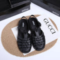 Black Roman-style sandals with buckle fastening and hollow-out design on low-top PVC upper