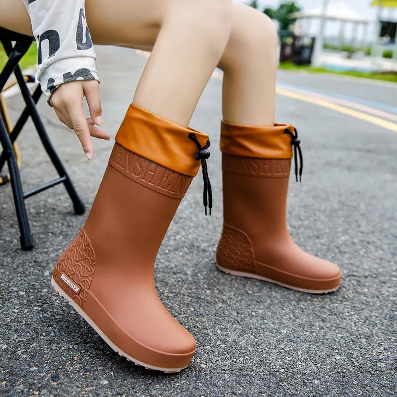 Women's solid colour PVC rain boots with non-slip soles in apricot, black, brown, and pink waterproof mouth options