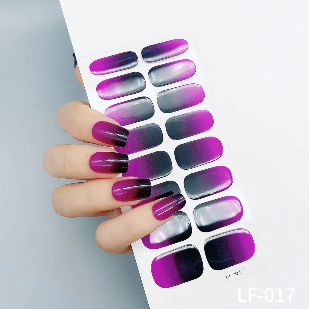 Set of 16 solid colour full nail art stickers showing patterns like cross, rose, tulip, and cartoon designs.