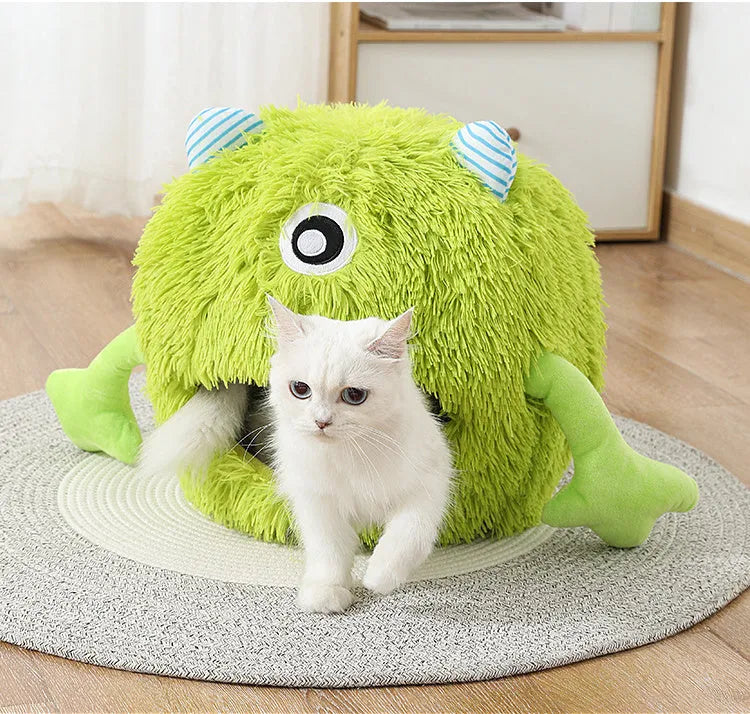 Round fluffy plush cat bed on a floor, showing its non-slip base, next to a resting cat.