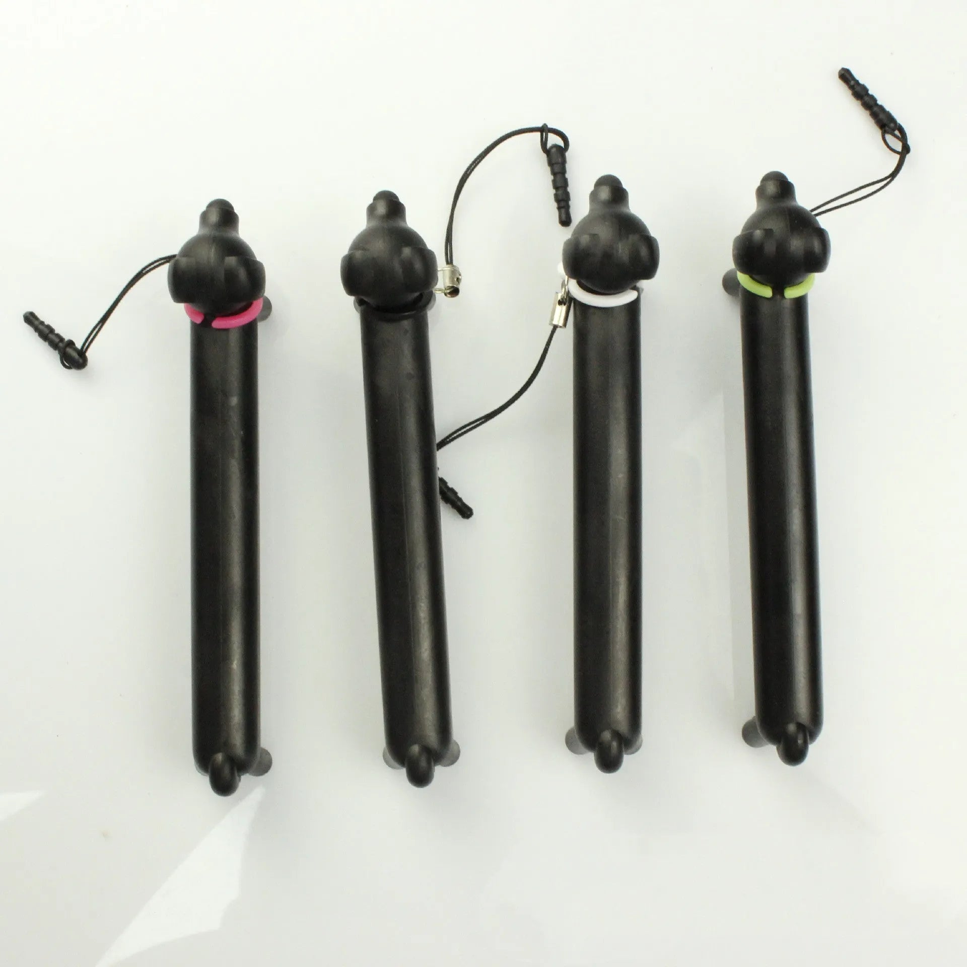 Black dog-shaped touch screen stylus showing length adjustment and phone holder function