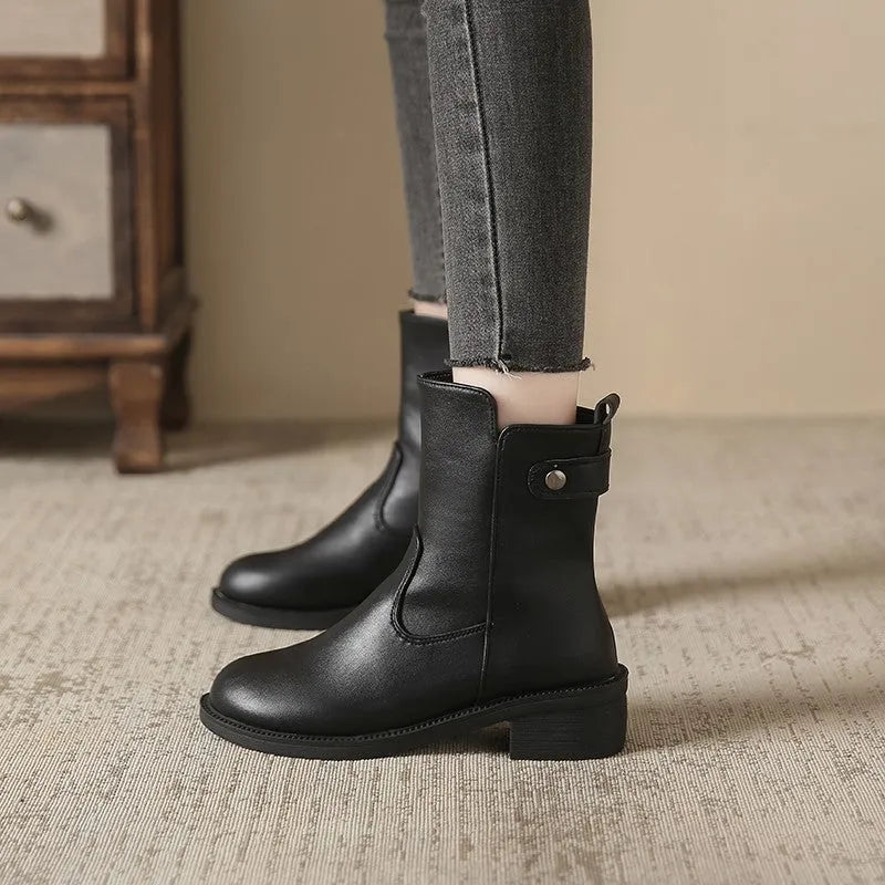Black women's short boots with side zip and round toe on a low rubber sole.