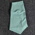 Women's high waist yoga shorts in nylon fabric, shown in pink litchi colour.