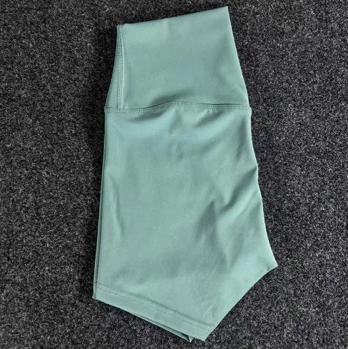 Women's high waist yoga shorts in nylon fabric, shown in pink litchi colour.