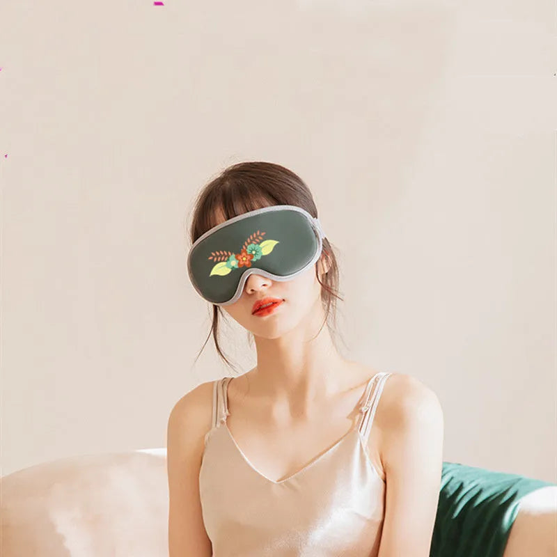Pink and green portable steam sleep massage goggles showing suede exterior and super fibre interior.