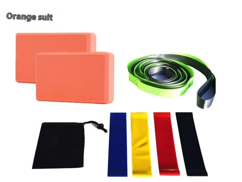 Yoga block eight-piece set with bricks, stretch belt, latex bands, and black storage bag on a floor.