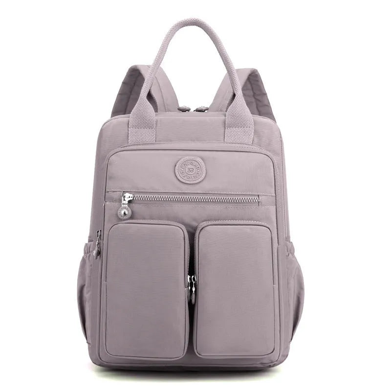 Women's waterproof nylon travel backpack with multiple internal compartments in various colours