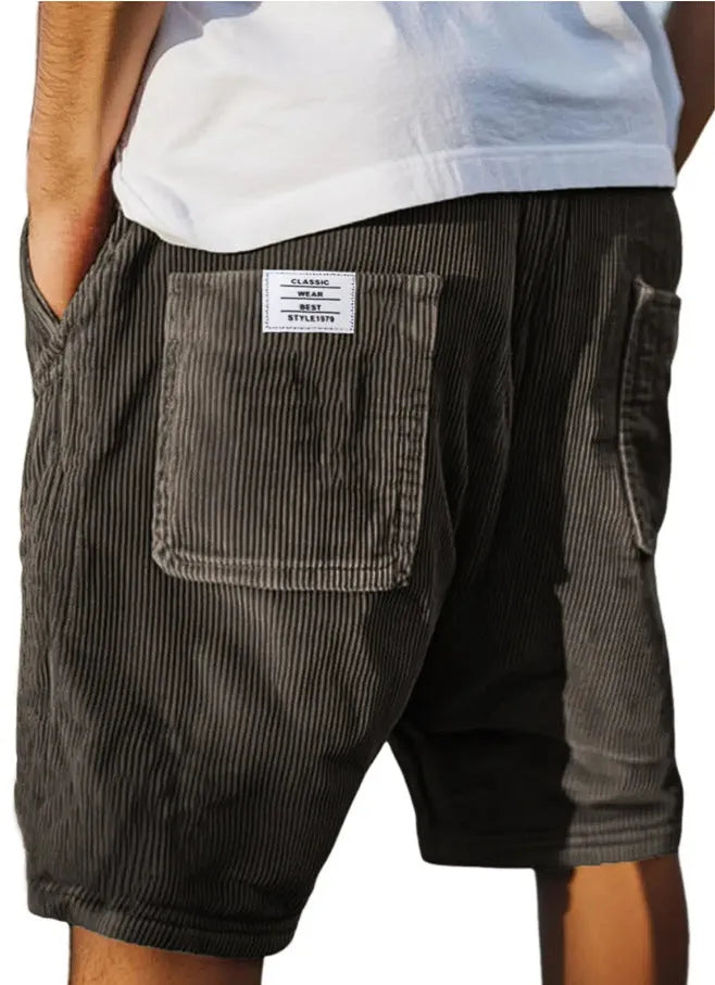 Men's grey straight-leg corduroy shorts with multiple pockets and embroidery detail on a hanger.