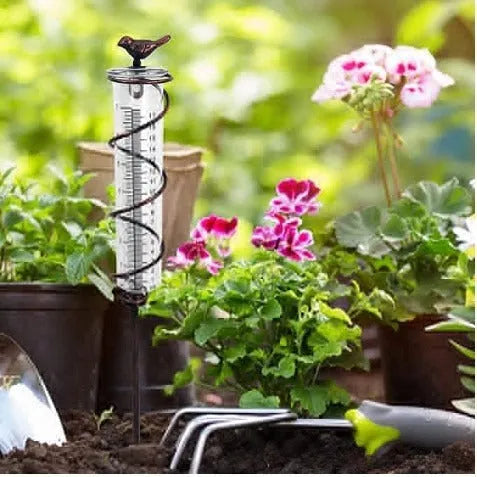 Cast iron hummingbird garden rain gauge with glass measurement tube showing 1-20cm scale