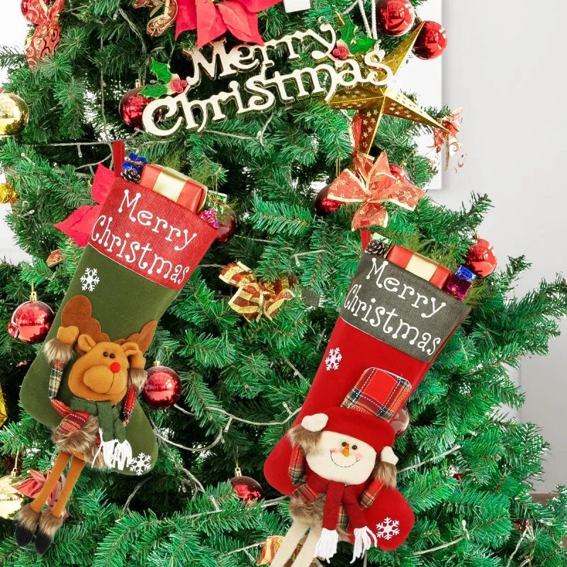 Set of three large 18-inch Christmas stockings with Santa, Snowman, and Reindeer 3D applique designs, hanging on a wooden mantel with festive decorations.