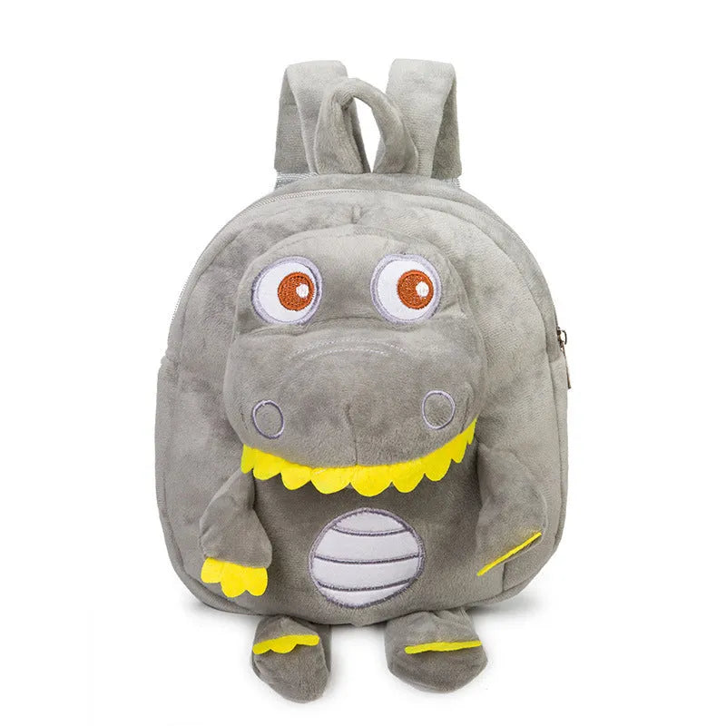 Soft blue plush dinosaur backpack for children with embroidery details and a single handle.
