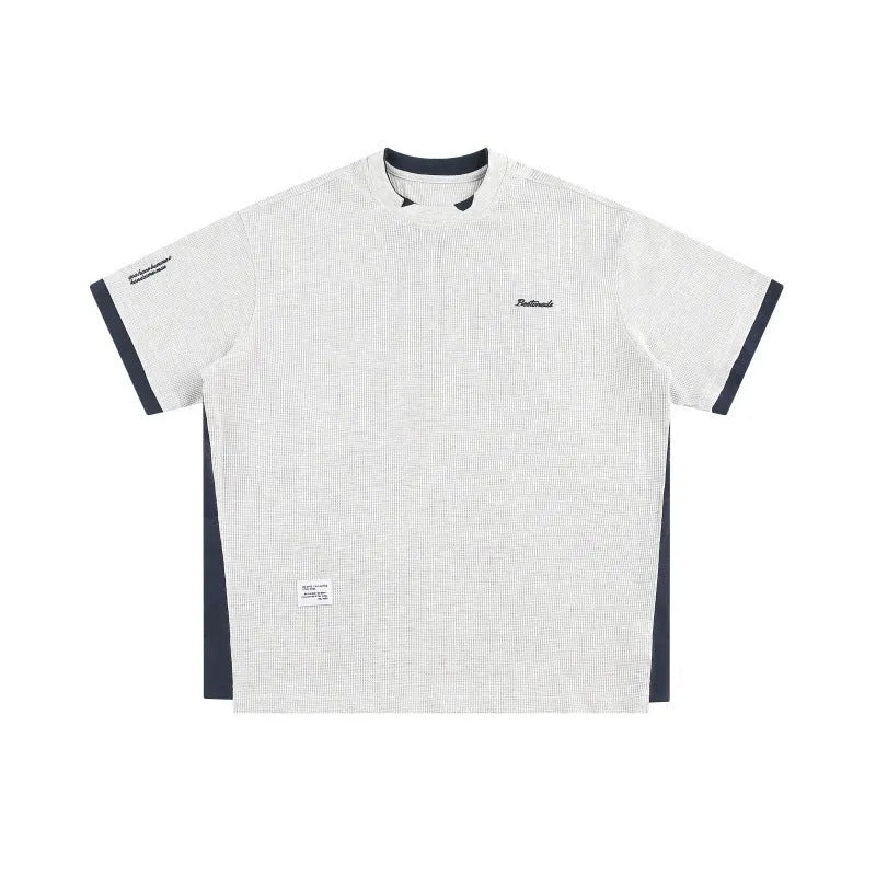 Retro alphabet embroidered loose waffle short-sleeved t-shirt in navy blue, laid flat.