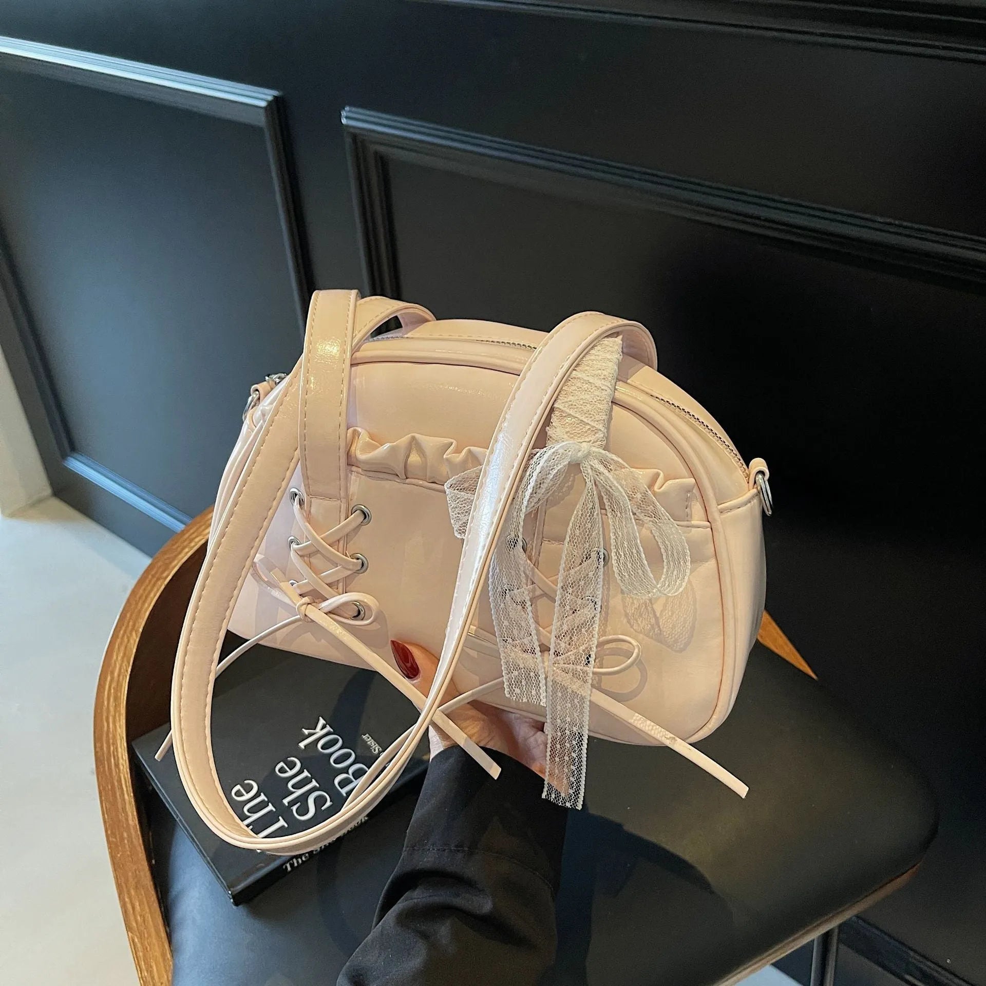 Ladies shoulder handbag with bandage bow design in PU leather showing phone pocket compartment