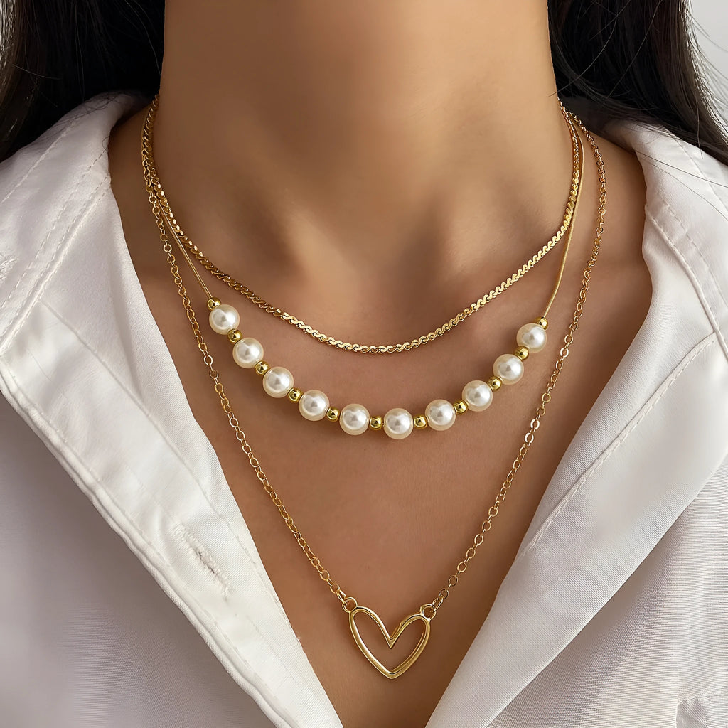 Vintage gold heart pendant necklace with pearl chain detailing showing adjustable length feature