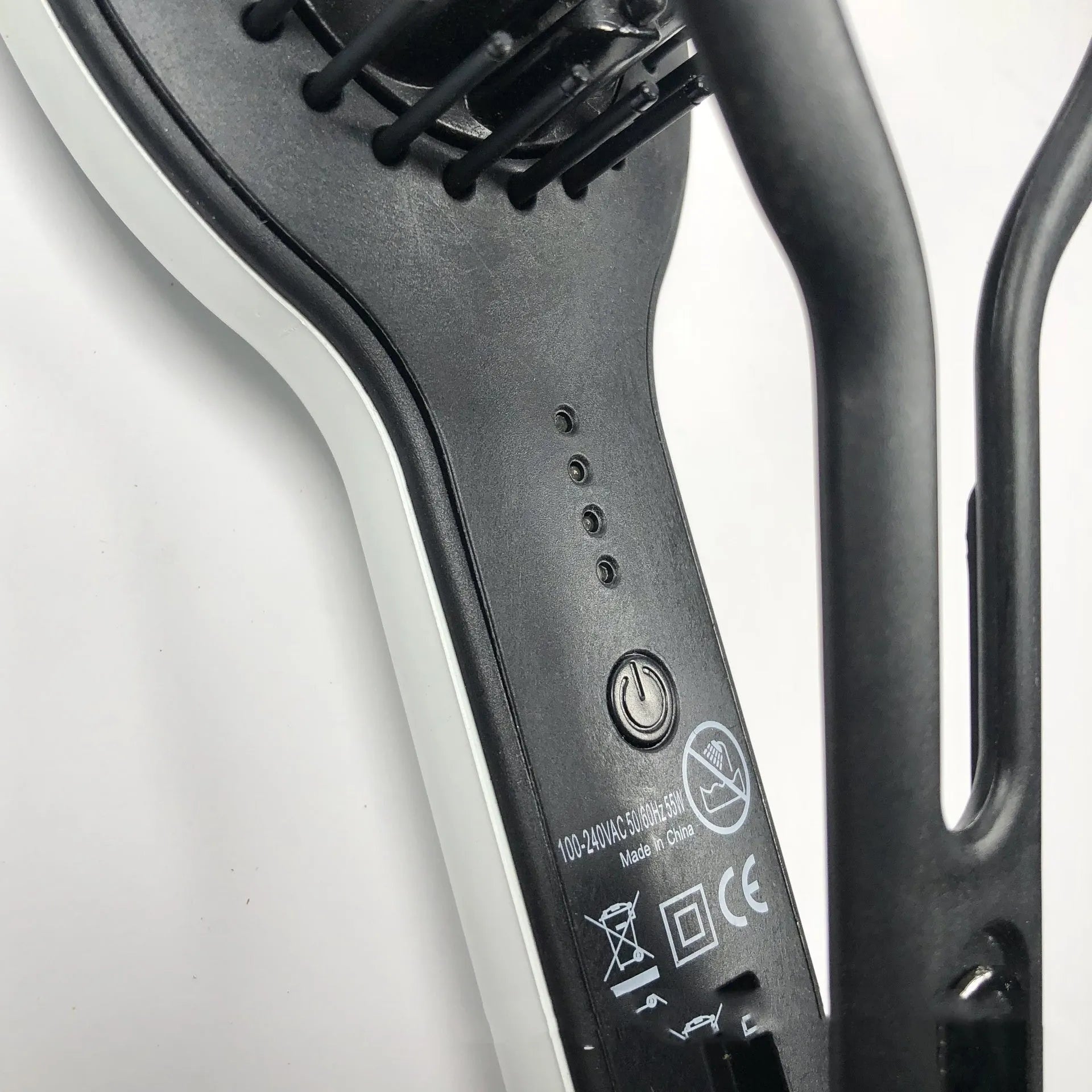Black electric hair straightener and curling iron comb with tourmaline ceramic heat conductor and 10 temperature settings