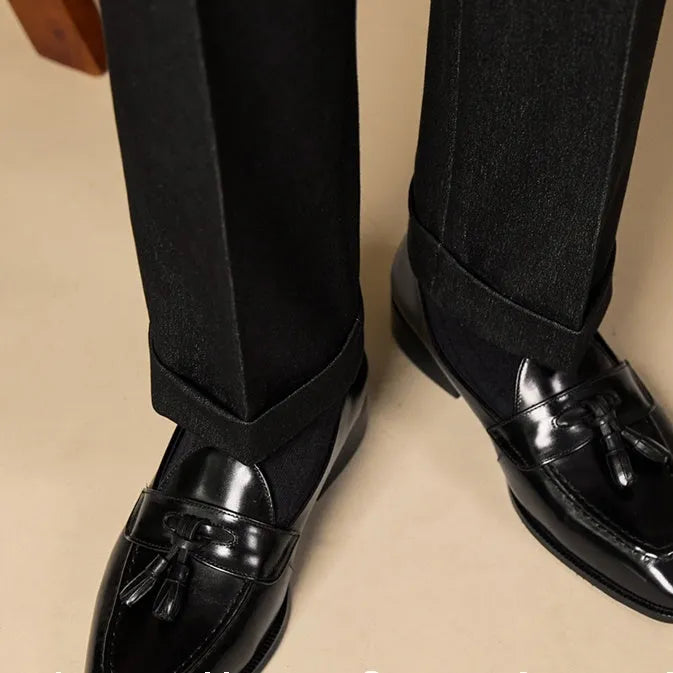 Men's black and brown polished leather tassel loafers with pigskin lining and rubber soles
