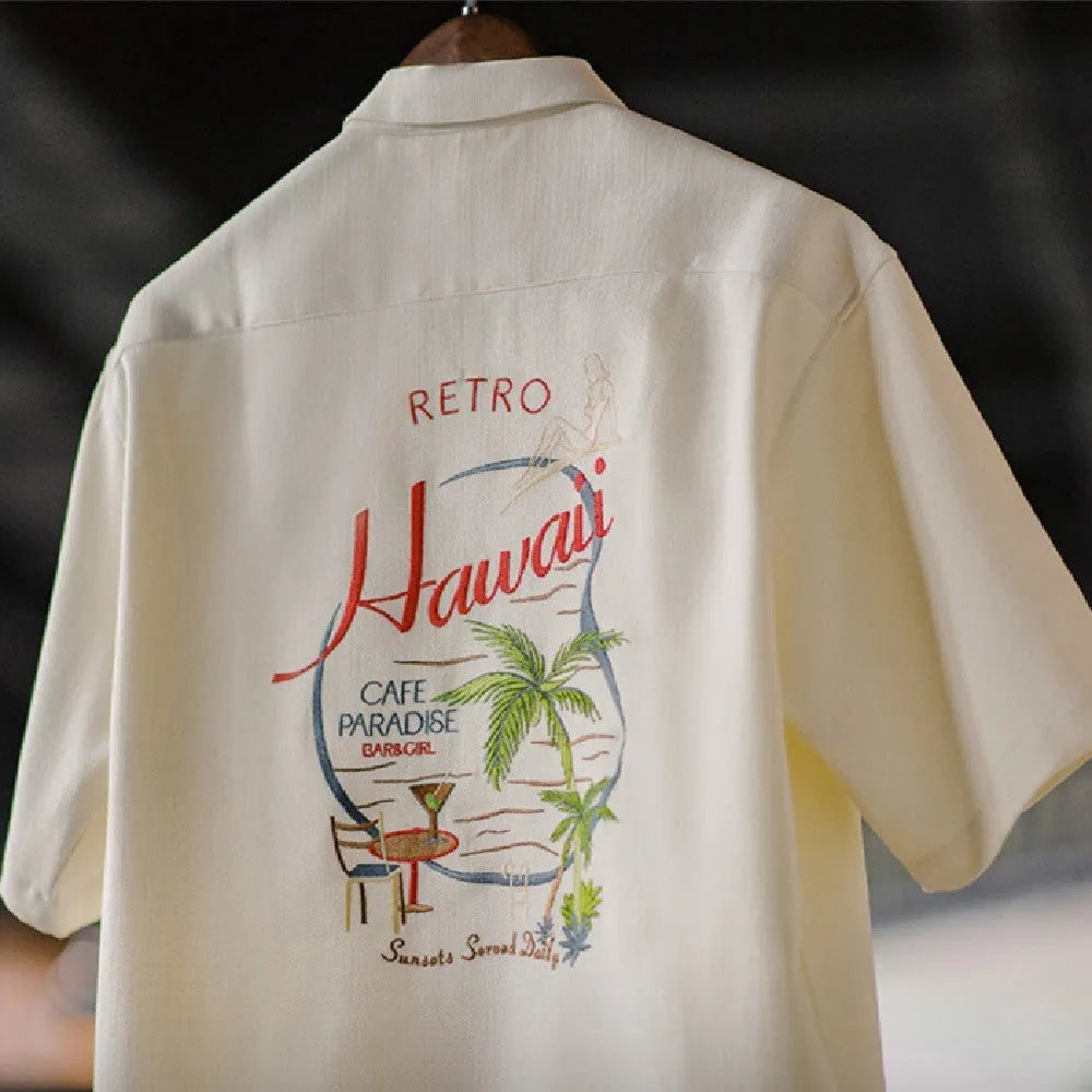 Light apricot men's short sleeve shirt with a bamboo floral pattern and a Cuban collar.