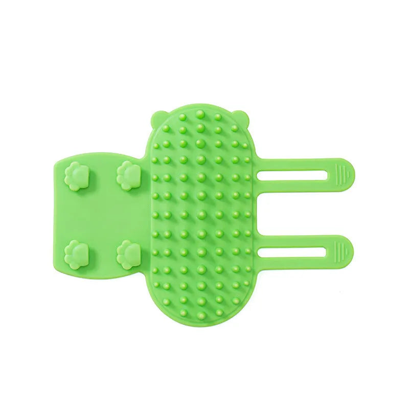 Silicone pet massage comb with adjustable strap attached to table leg