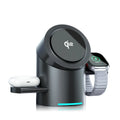 Three-in-one magnetic wireless charger stand in dark grey charging a phone, earphones, and Apple Watch