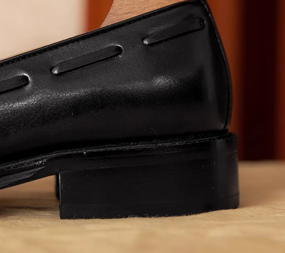 Men's black and brown genuine leather slip-on loafers with a polished finish and rubber sole.