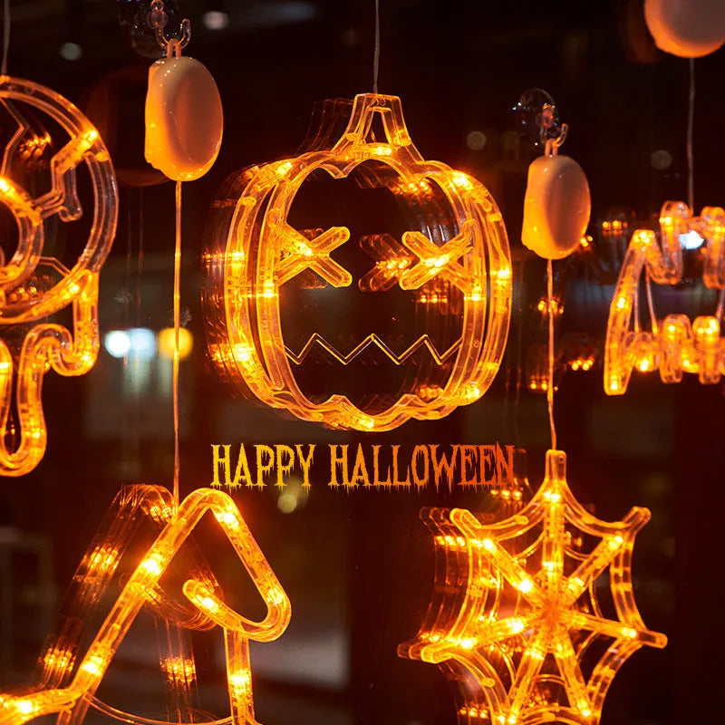 Seven Halloween LED window lights with spider, pumpkin and ghost designs on suction cups