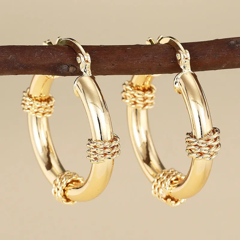 Geometric copper earrings for women in golden colour with ring and line design elements