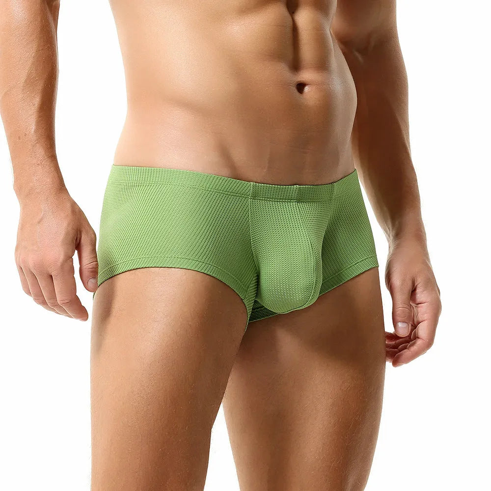 Men's solid colour low-waist nylon boxer shorts on a white background.
