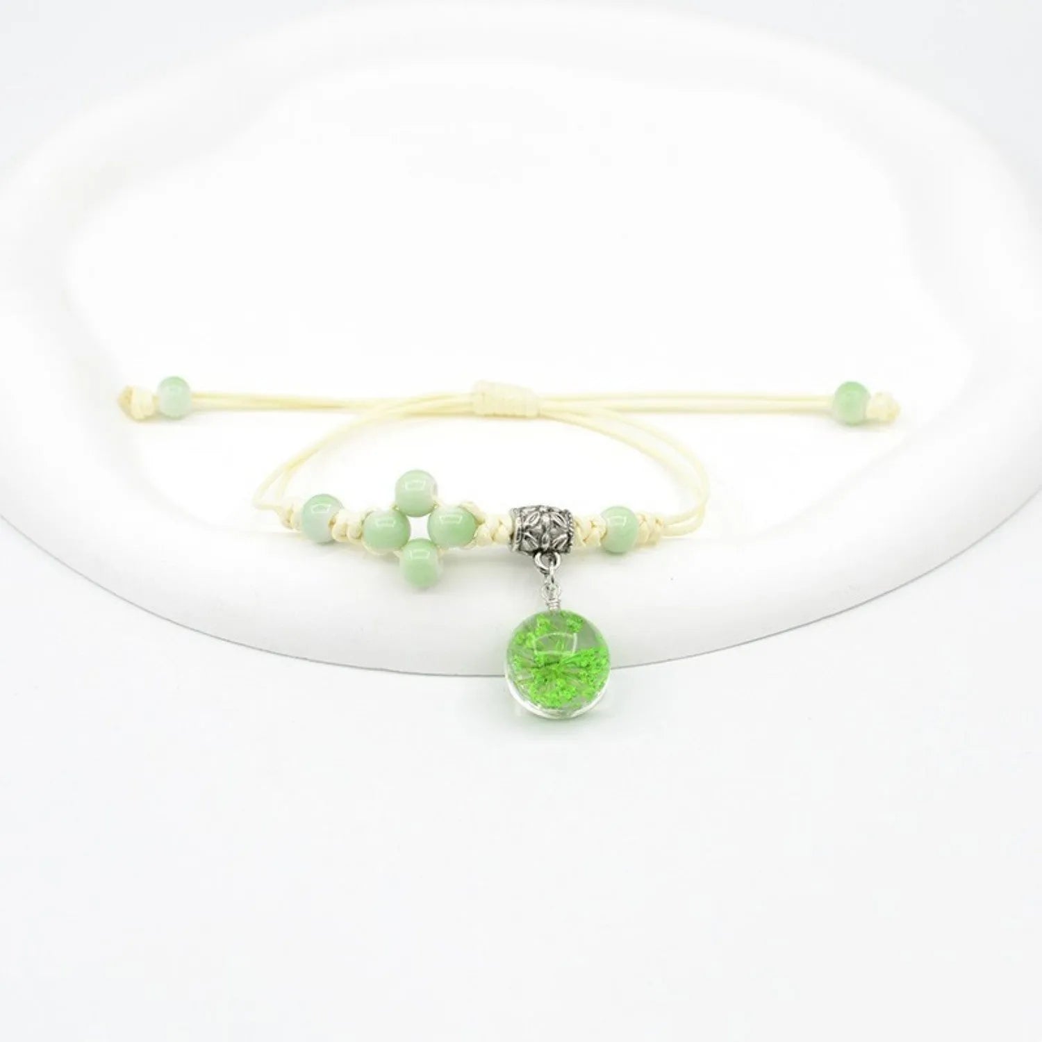 Hand-woven glass bracelet with 1.4cm beads containing real dried flowers in various colours