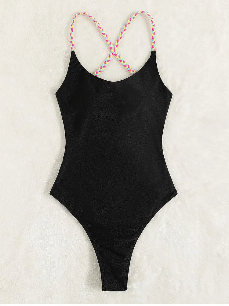 Black solid colour women's one-piece swimsuit with a backless, sleeveless design on a model.