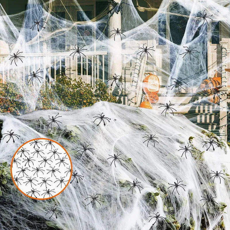 White cotton spider web Halloween decoration with plastic spiders draped over furniture