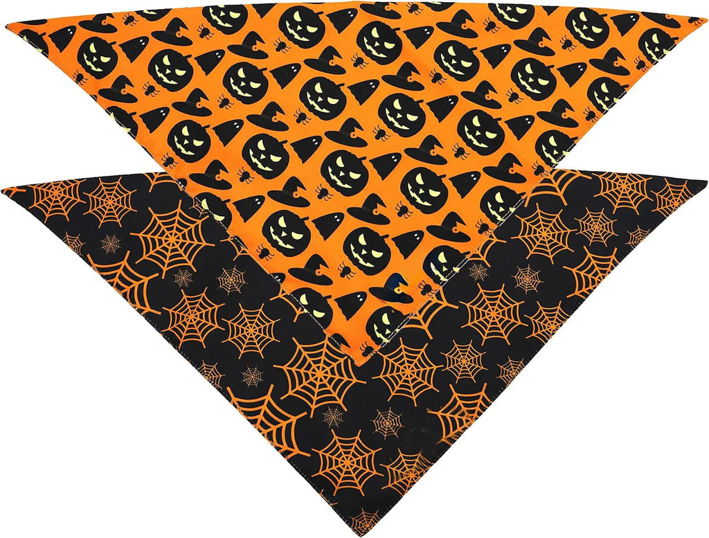 Reversible black and orange Halloween dog bandana with pumpkin and spider web patterns laid flat