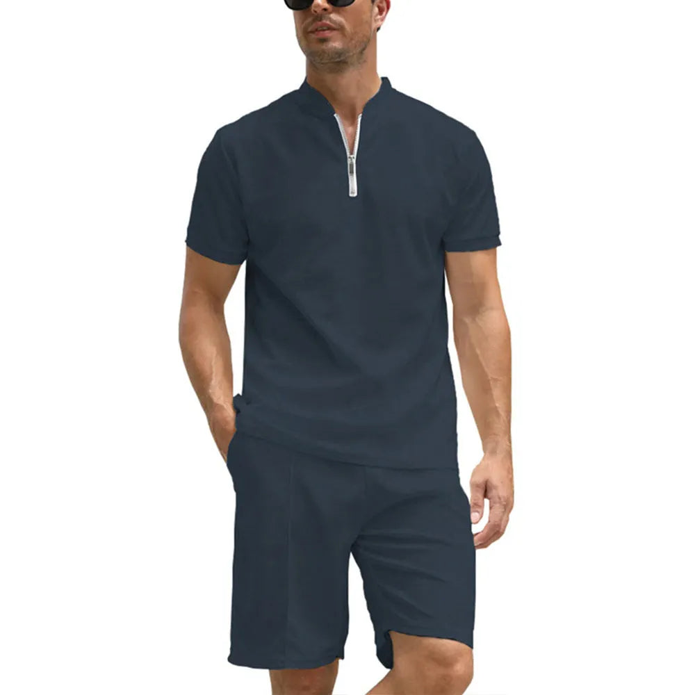 Man wearing a solid colour polo shirt and matching trousers from a two-piece set in beaded bird's eye polyester fabric.