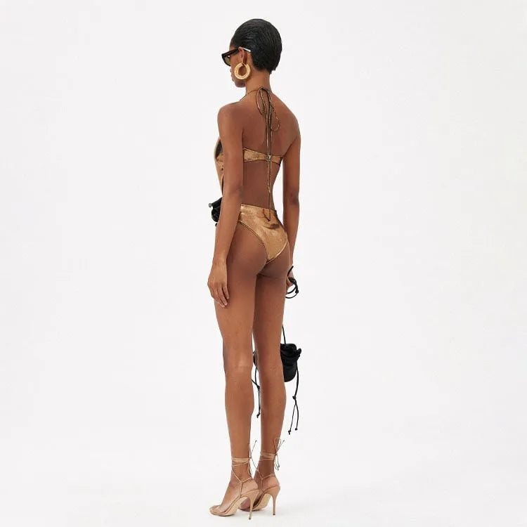 Gold coloured handmade one-piece swimsuit with a halter neckline and hollow-out design.