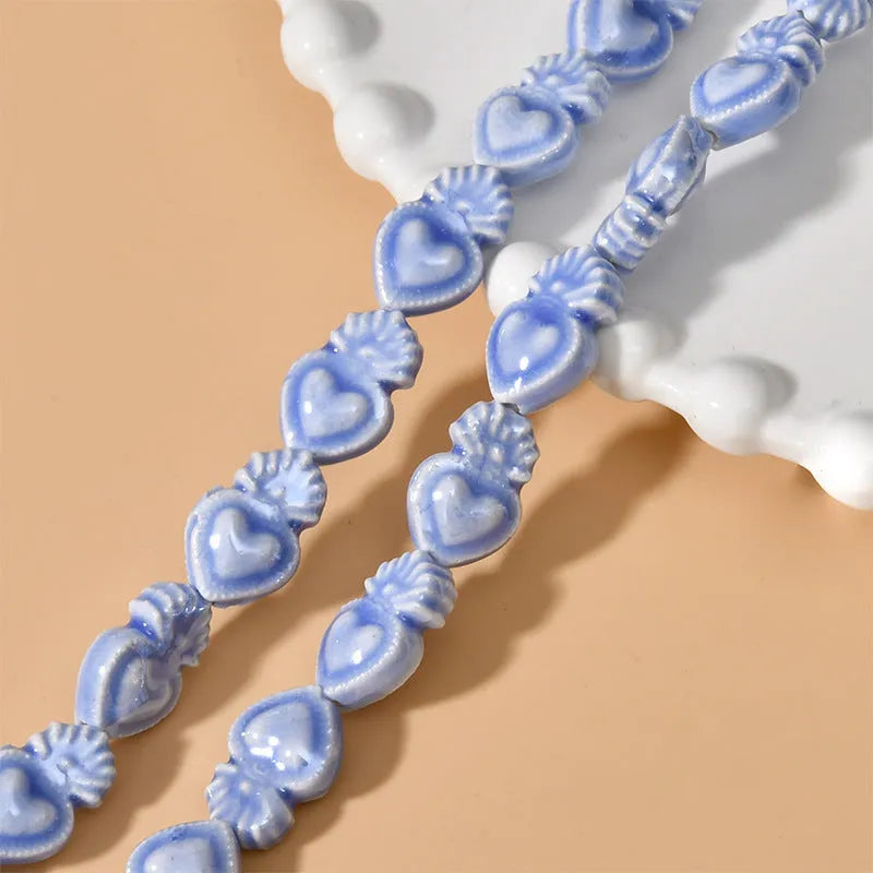 Ceramic heart torch beads in various colours for jewellery making, approximately 10mm by 15mm with straight hole
