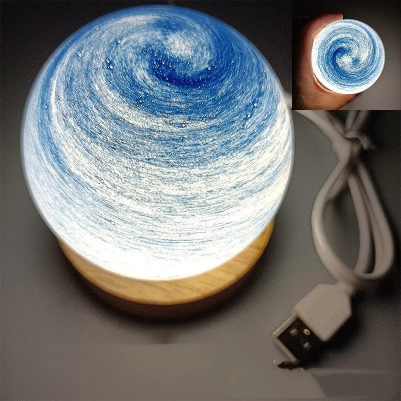 Planet night light with USB cable and base in modern simple design showing spherical shape