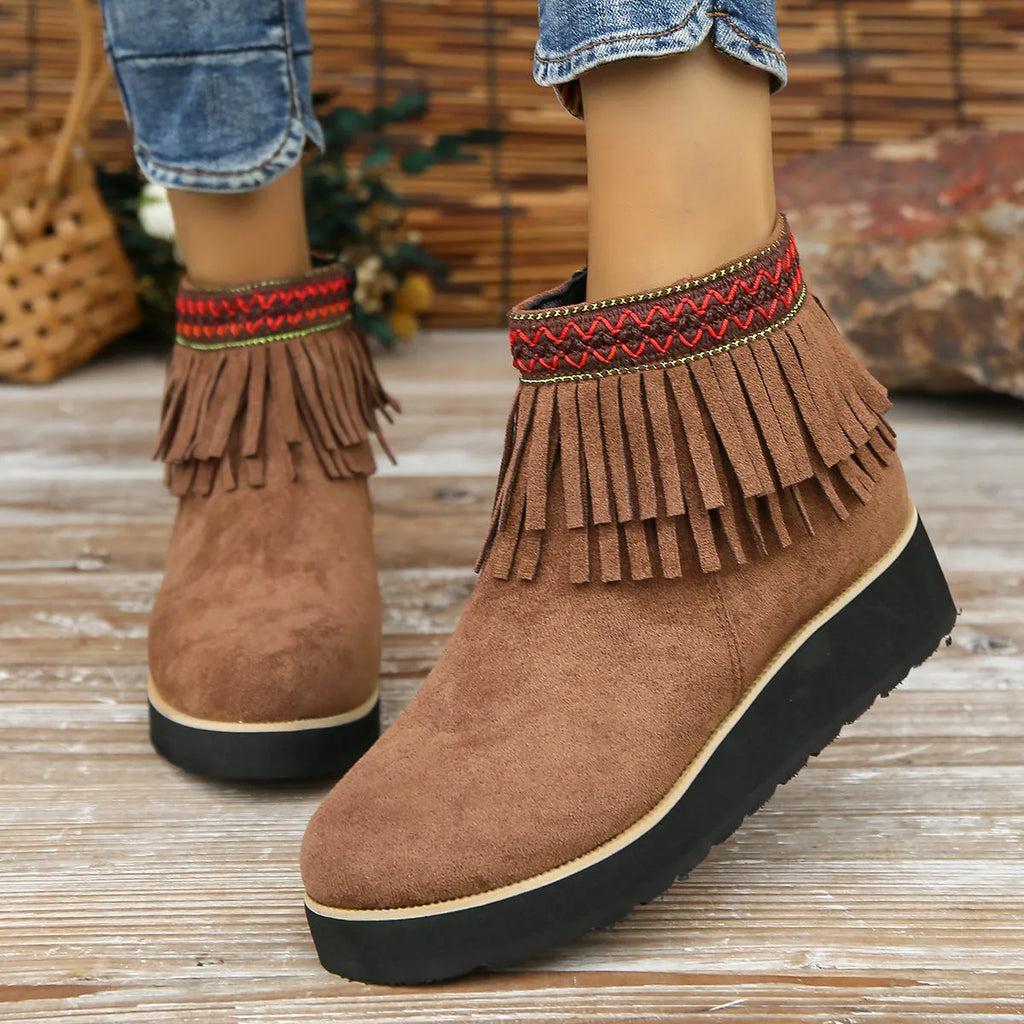 Women's dark brown suede wedge bootie with side zip, tassel detail, and thick rubber sole