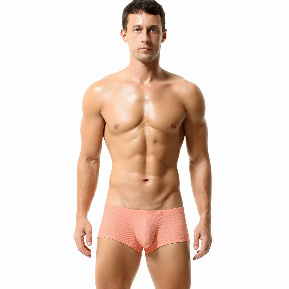 Men's solid colour low-waist nylon boxer shorts on a white background.