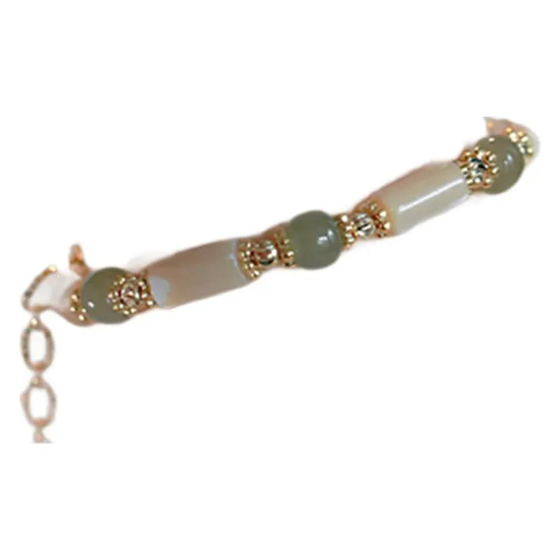 Handmade women's Hetian jade bracelet with round beads in geometric design on wrist