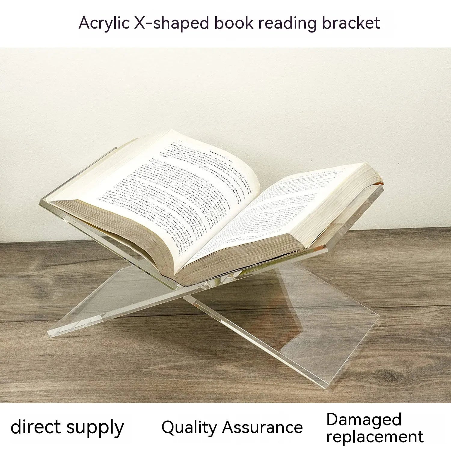 Clear acrylic X-shaped book display stand holding a hardback book on a wooden desk.