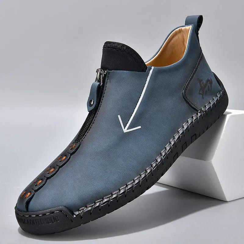 Men's black leather zip-up boots with round toe and hand-stitched rubber sole on a white background.