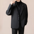 A man's loose fit suit jacket in a chemical fibre blend fabric, shown in one of four available colours.