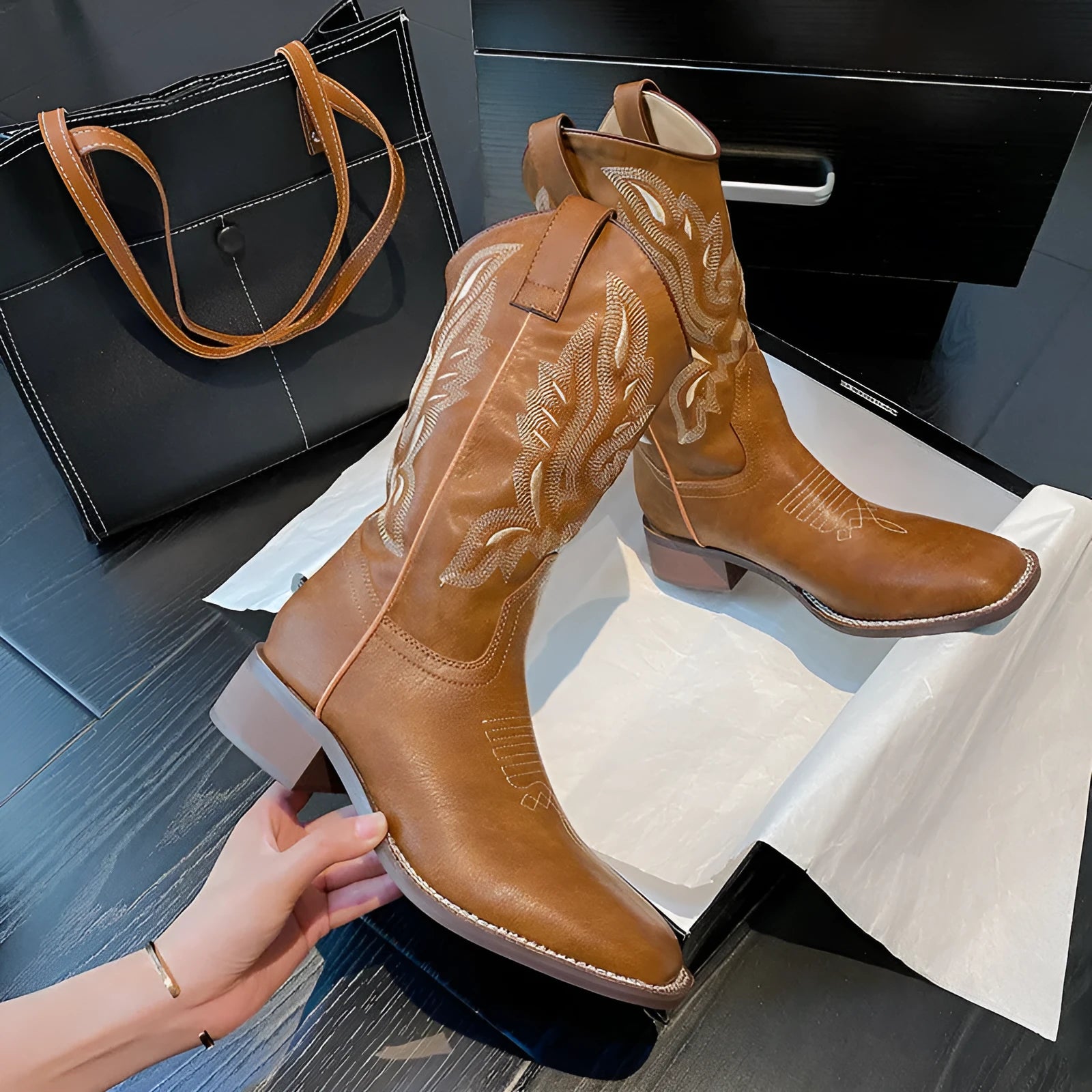 Brown women's mid-calf Martin boots with embroidered detail, round toe, and low square heel.