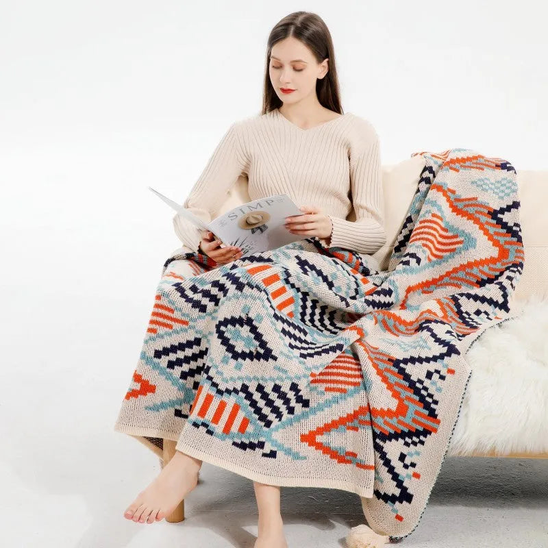Acrylic sofa blanket with tassel fringe in geometric pattern, showing 130 cm width measurement