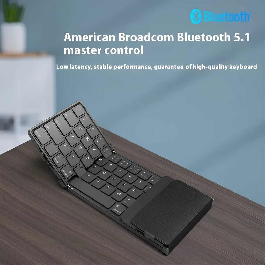 Black folding Bluetooth keyboard with touchpad option next to a mobile phone