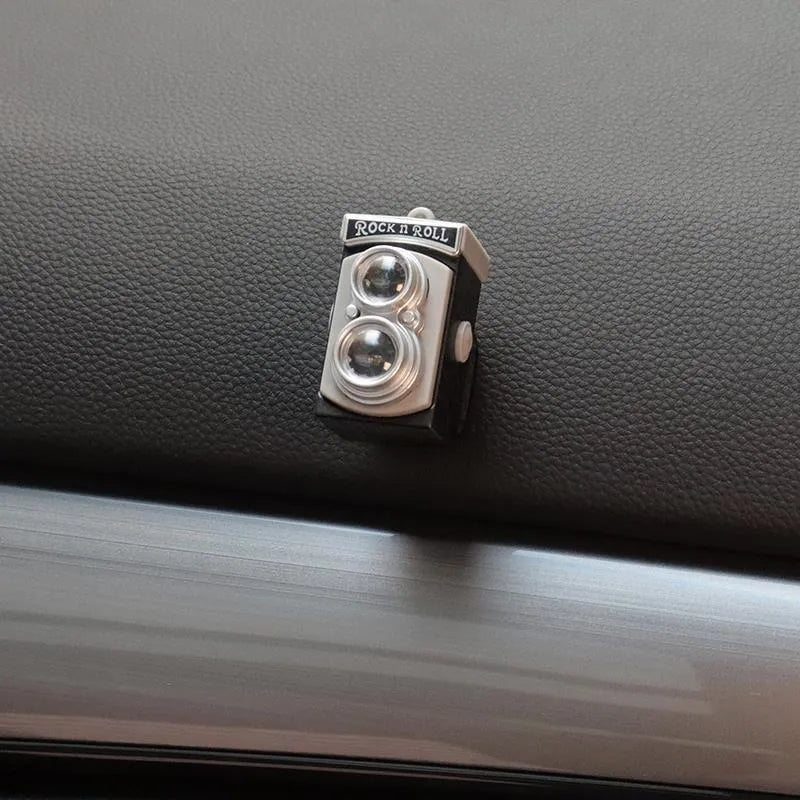 Pack of four retro camera dot design adhesive hooks for car interiors.