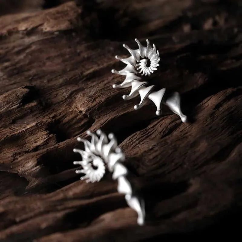 Three-dimensional matte conch stud earrings with irregular geometric shapes
