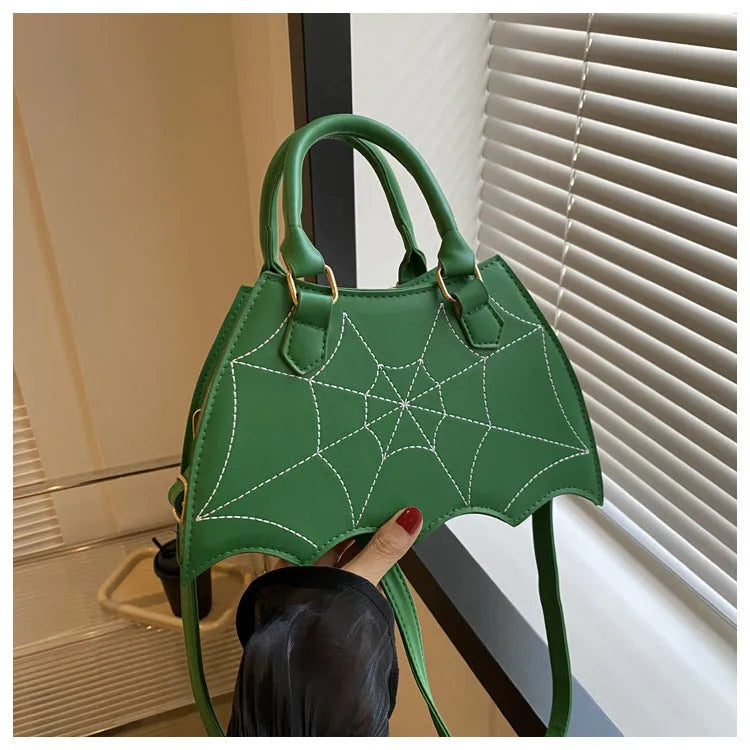 Women's small square PU saddle bag with spider web pattern, crossbody strap, and top handle, available in six colours including black and red