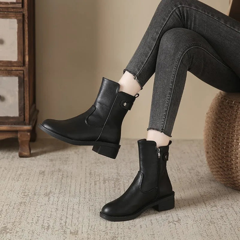 Black women's short boots with side zip and round toe on a low rubber sole.