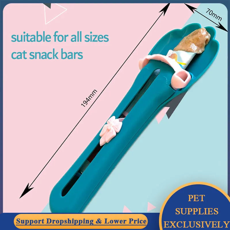 Pink and green pet feed spoon with squeezer mechanism for wet food and treat dispensing