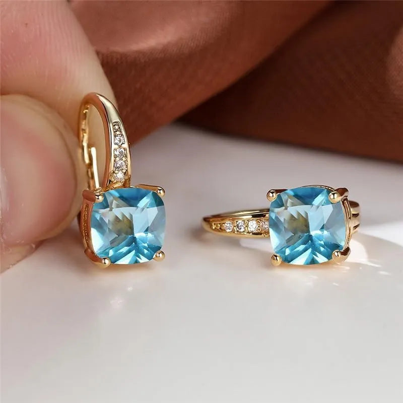 Square geometric ear hook studs with a round zircon stone, shown in a gold electroplated finish.